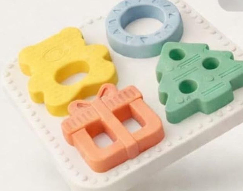 The Babylul puzzle board with all four shapes seated